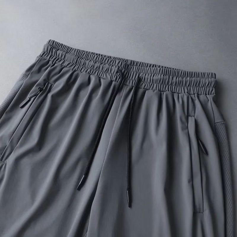 Stack of folded men's athletic shorts in multiple colors, showcasing versatility in sportswear.