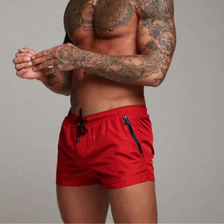 Performance men's swim trunks with quick-dry stretch fabric & adjustable drawstring for active wear.