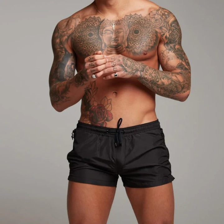 Comfortable men's quick-dry stretch swim trunks, perfect for summer beach days & active water sports.