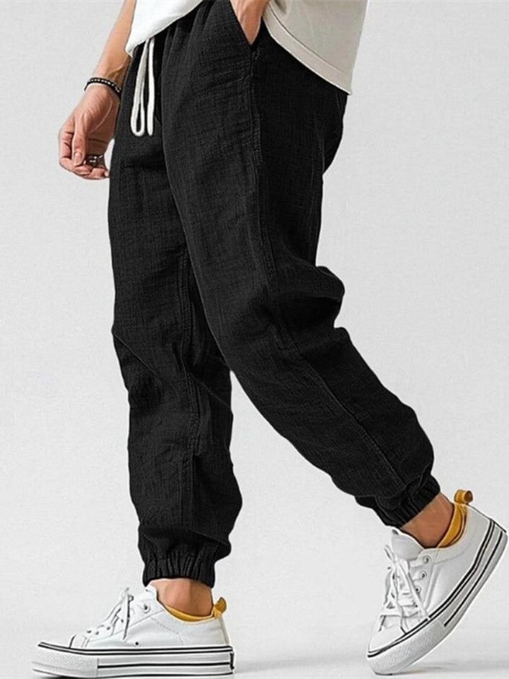 Man wearing relaxed fit cuffed joggers, showcasing casual style & comfort for everyday wear.