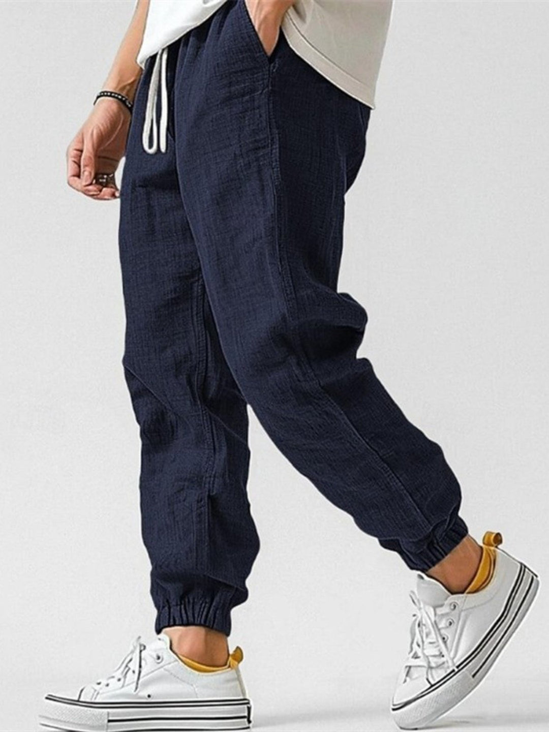 Versatile men's casual joggers, relaxed fit & cuffed design, ideal for travel, summer, or streetwear.
