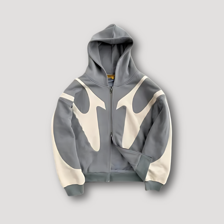 Close-up of a men's relaxed fit zip hoodie, showcasing fabric texture and modern design for streetwear.