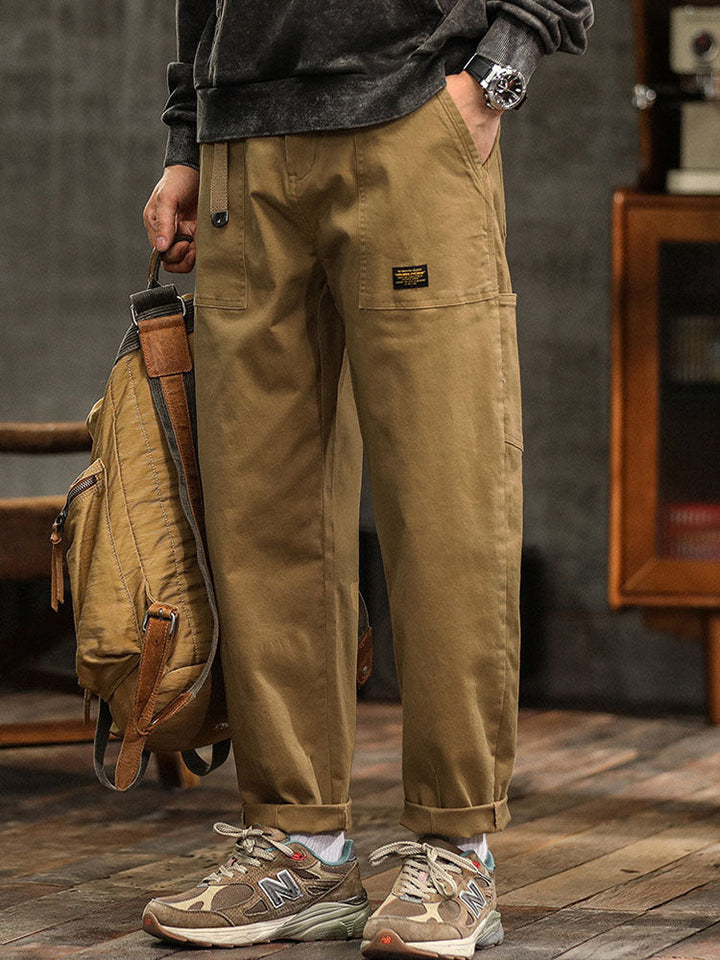 Men's versatile utility pants in stone beige with a relaxed fit, suitable for various casual fashion ensembles.