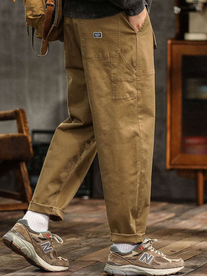 Relaxed fit men's casual pants, utility style, providing ample movement and a contemporary silhouette.