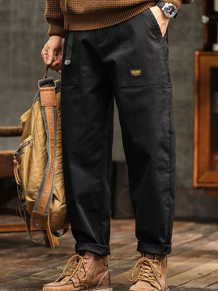 Stylish men's relaxed fit utility pants in black, a staple for modern casual wear and functional fashion.