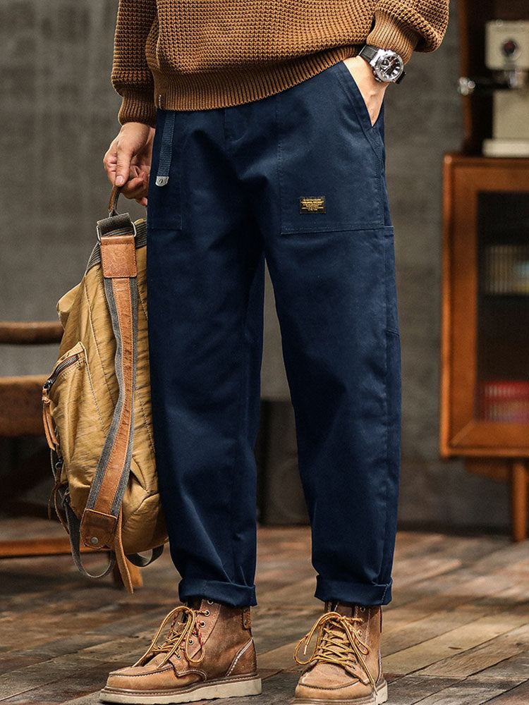 Close-up of the fabric texture and stitching on men's relaxed fit utility pants, emphasizing durability.