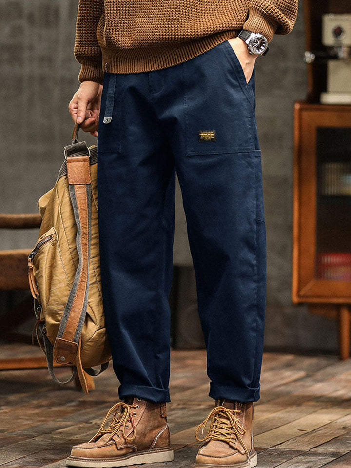 Close-up of the fabric texture and stitching on men's relaxed fit utility pants, emphasizing durability.