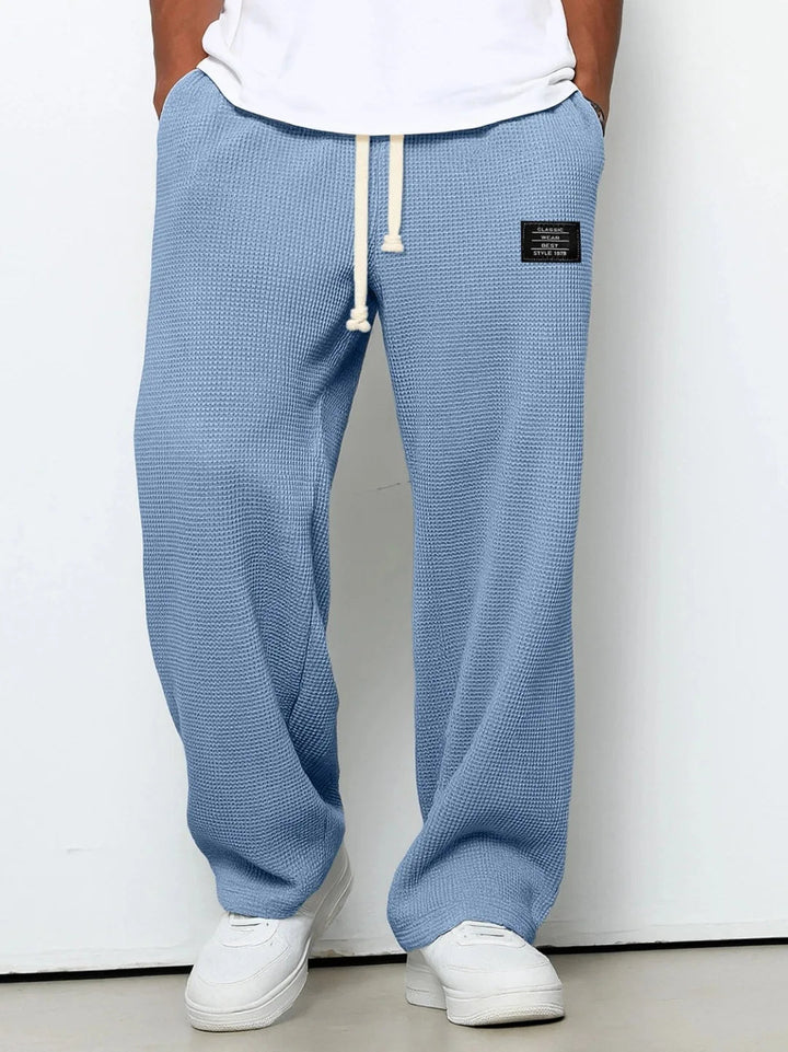 Men's relaxed fit waffle knit lounge pants with drawstring for ultimate comfort & casual home wear.