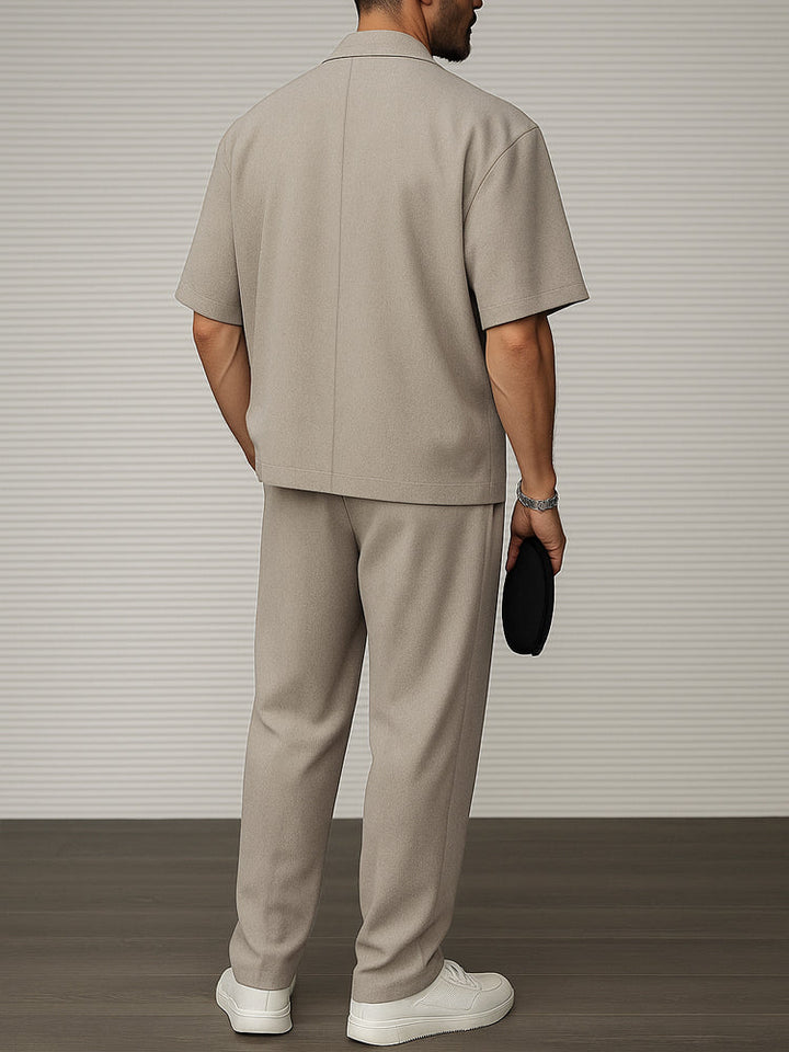 Detail of men's short sleeve blazer & tailored trousers fabric. Premium menswear two-piece for formal & smart casual events.