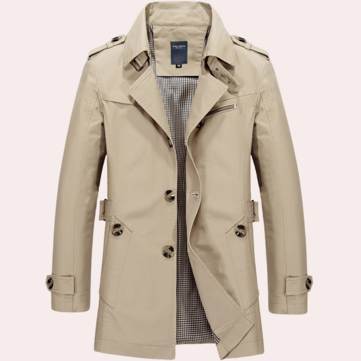 Close-up of the double-breasted detail on a sleek men's slim fit trench coat, winter fashion.