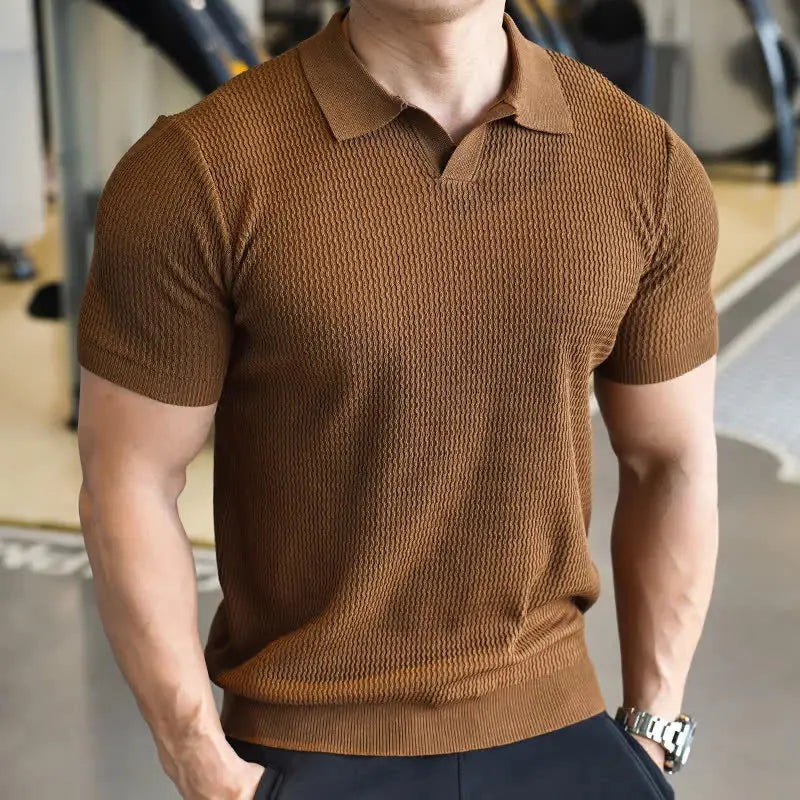 Man in a comfortable slim fit textured short sleeve polo shirt. Ideal collared top for modern casual men's style.