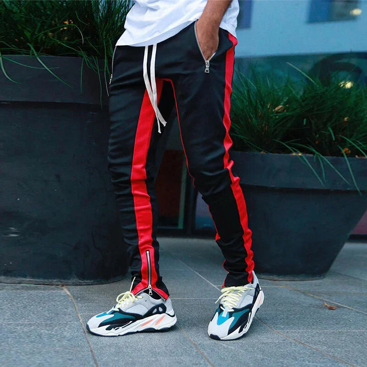 Athletic men's slim fit track pants featuring stylish zip hems, great for sports or daily comfort.
