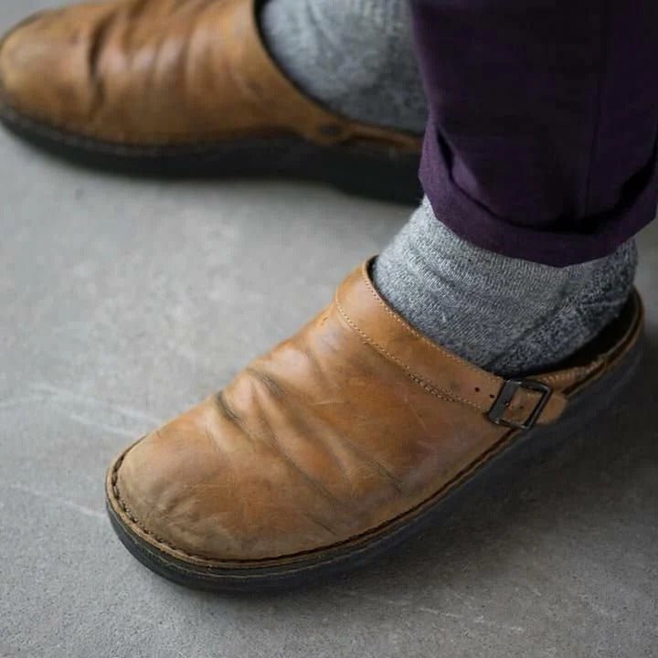 Classic men's casual mules with a secure heel strap, offering style, comfort, and durability.