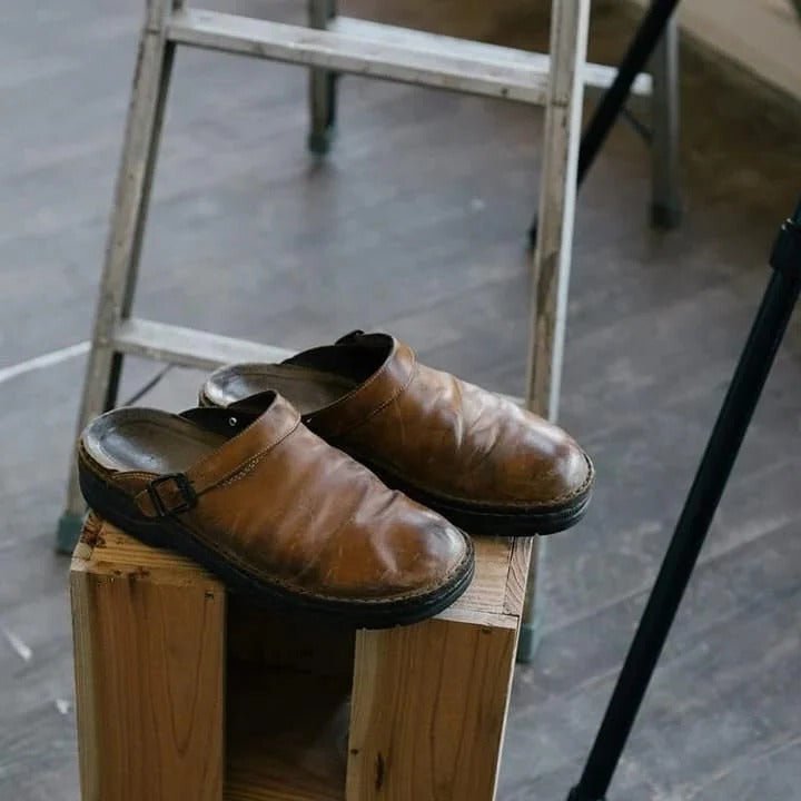 Convenient men's slip-on mules with secure heel strap, great for quick on-the-go comfort.