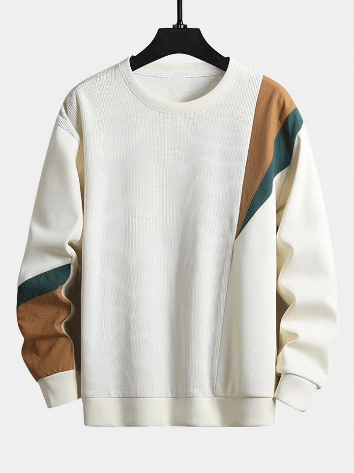 Modern men's color-block sweater for a versatile fall outfit. Stylish knitwear, perfect for cool weather.