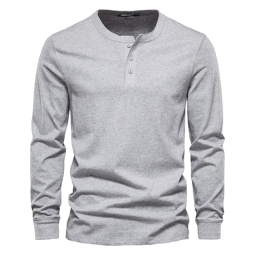 Close-up of the button neck placket on a men's long sleeve henley shirt, showcasing quality detail