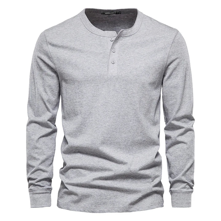 Close-up of the button neck placket on a men's long sleeve henley shirt, showcasing quality detail