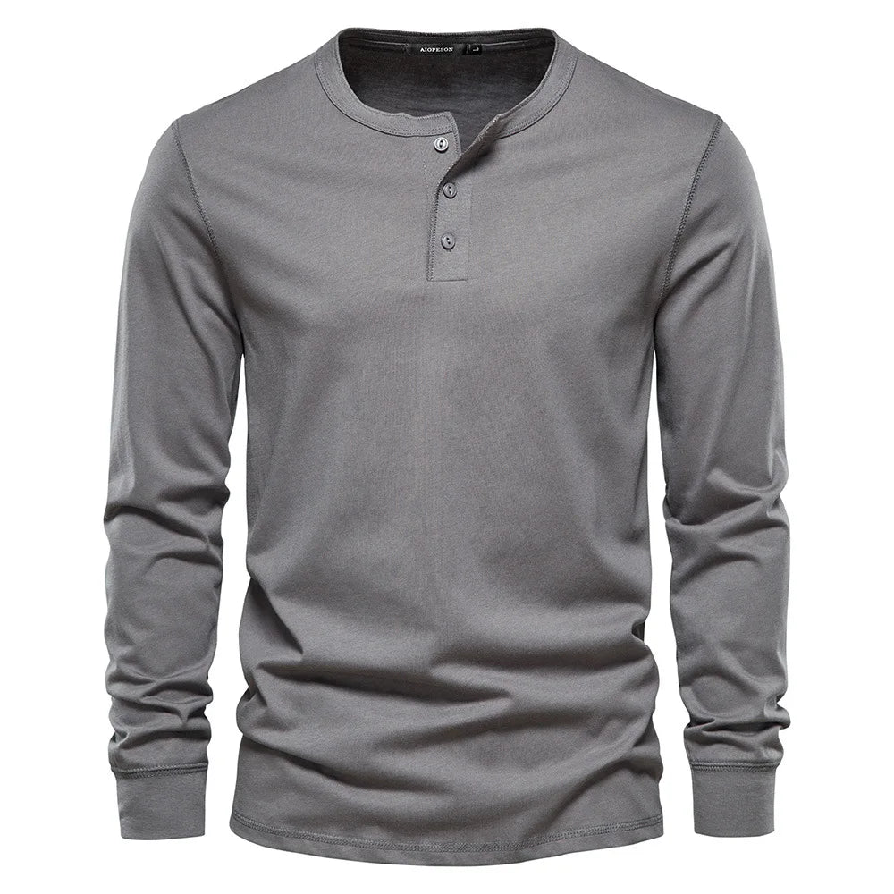 Men's long sleeve henley shirt folded neatly, ready for everyday wear or travel, a versatile casual top