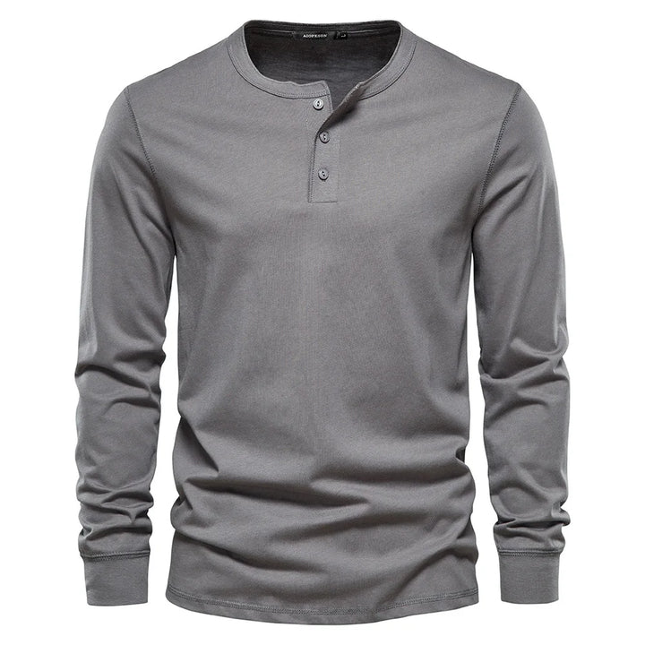 Men's long sleeve henley shirt folded neatly, ready for everyday wear or travel, a versatile casual top