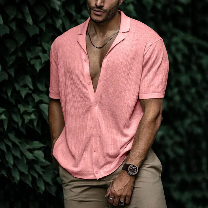 Man enjoying beach day in a relaxed fit textured Cuban collar summer shirt. Ideal warm weather style.