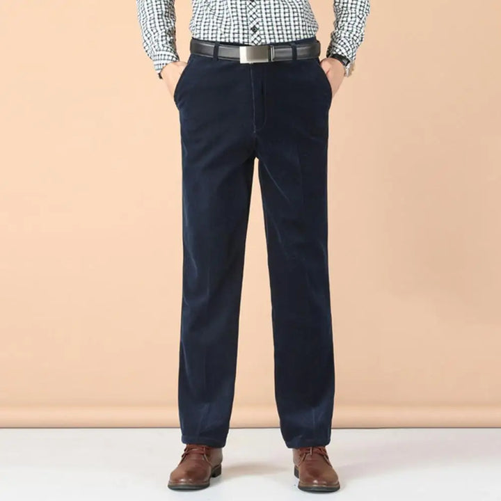 A man models stylish navy velvet dress pants, ideal for special occasions and elegant comfort.