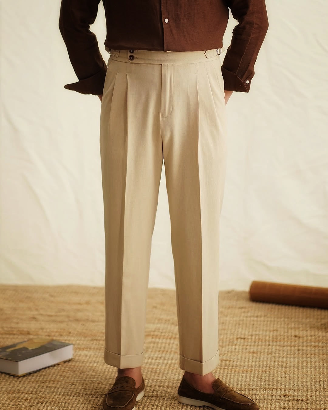 Men's high-waisted tailored trousers with side buckle, offering a sophisticated & modern look.