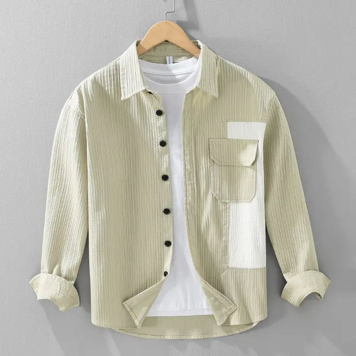 Close-up of corded fabric on a men's button-up shirt, cream beige with textured finish