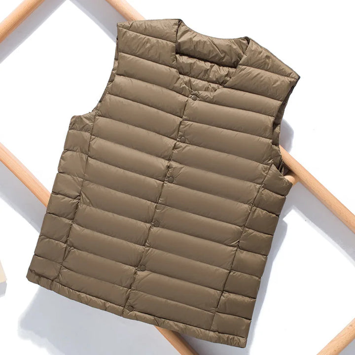 Modern men's padded sleeveless jacket, a stylish layering piece for urban or outdoor exploration. Ultralight.