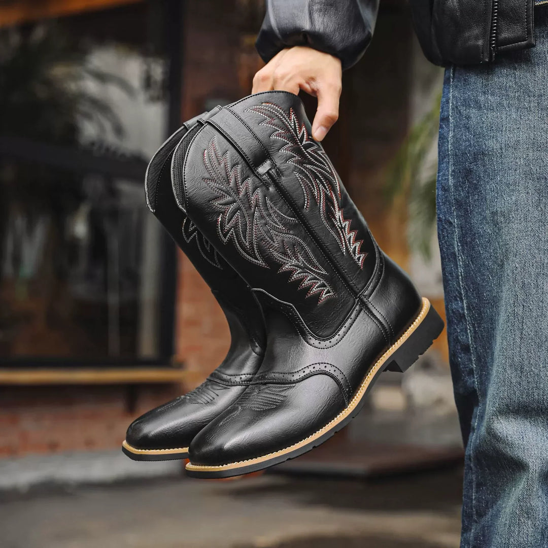 Close-up of a men's brown leather cowboy boot, showcasing detailed stitching, rich texture, and a pointed toe
