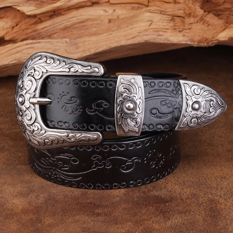 Black leather western belt featuring an embossed floral pattern & a prominent engraved metal buckle.