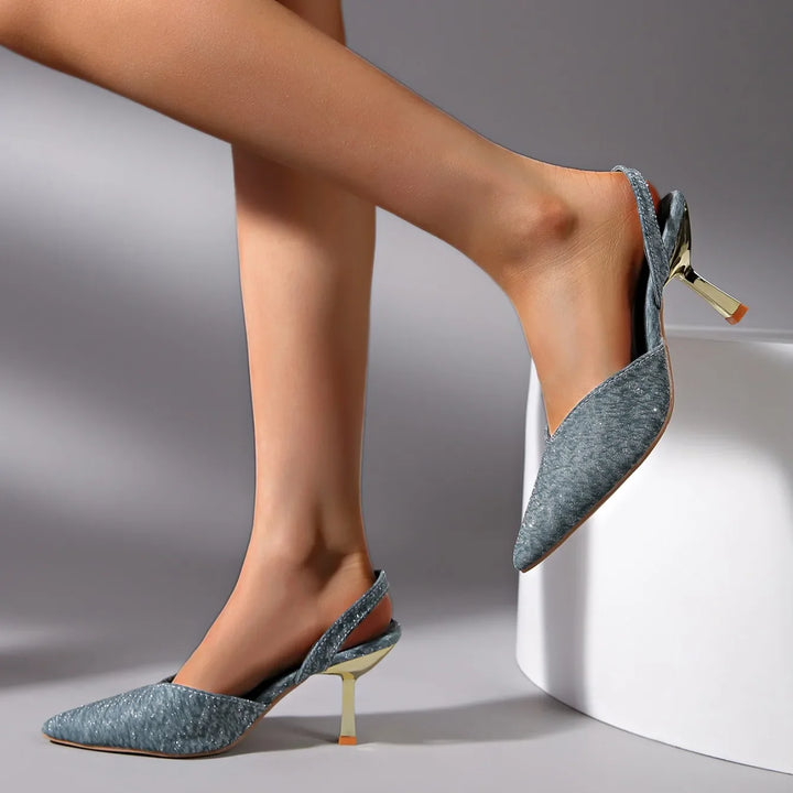 Close-up of a women's metallic pointed toe slingback heel, showcasing the intricate design