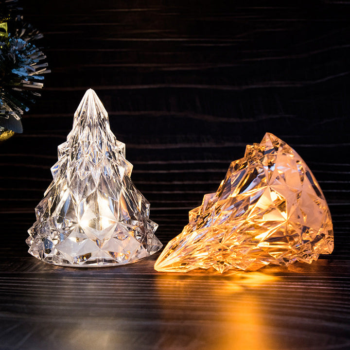Mini LED crystal Christmas tree night light illuminating a dark room, festive ambiance