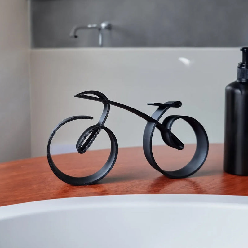 Close-up of minimalist bicycle sculpture, sleek black metal art, elegant office decor accent