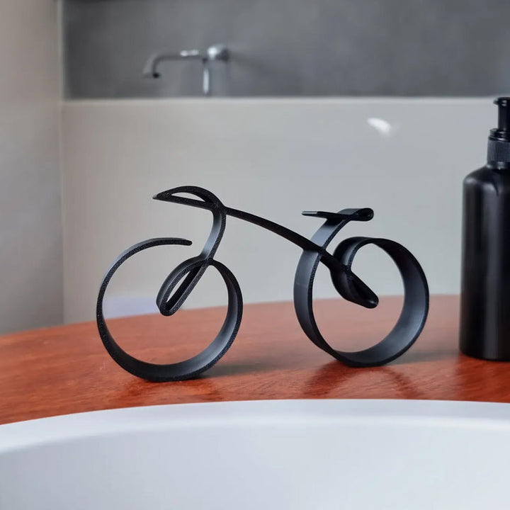Close-up of minimalist bicycle sculpture, sleek black metal art, elegant office decor accent