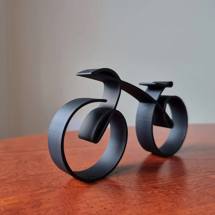 Side view of modern wireframe bicycle sculpture, minimalist desk decor for discerning cyclists