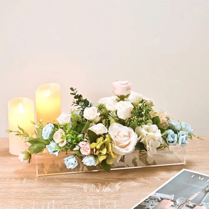 Modern transparent acrylic vase catching light, a versatile decor piece for offices and homes.