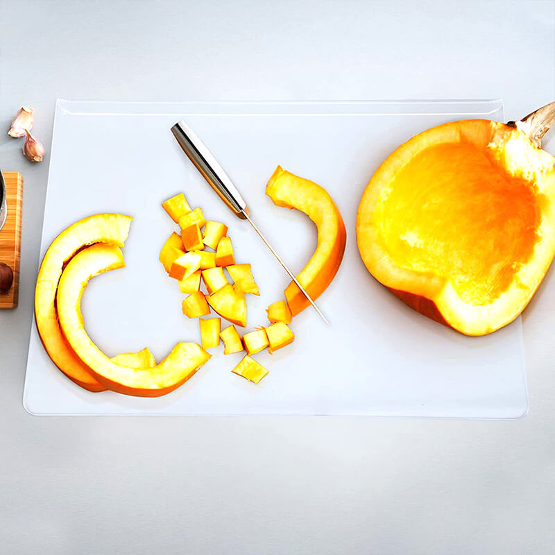 Durable clear acrylic non-slip cutting board, perfect for hygienic food preparation in any modern kitchen.
