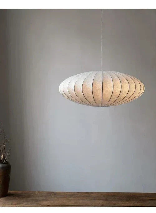 Modern pendant light featuring sparkling crystals & a soft silk lampshade, ideal for luxury decor.
