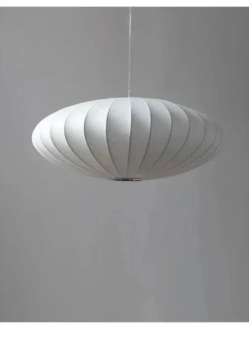 Stylish crystal pendant light with a silk shade, ideal modern lighting for luxurious living rooms.