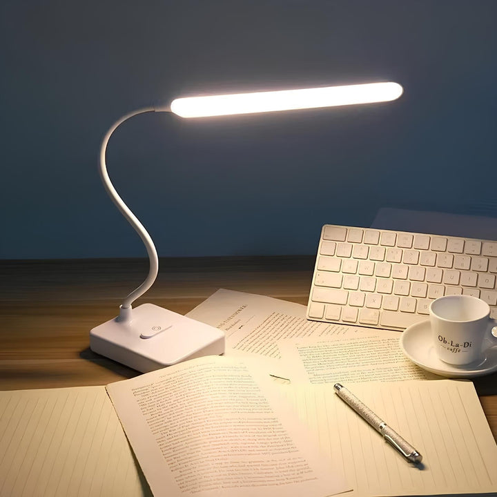 Sleek flexible LED task light, enhancing office or study with adjustable brightness & modern design.