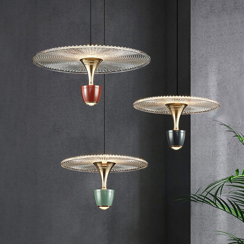 Decorative Glissara pendant ceiling lamp creating warm ambient light over a dining room table, enhancing modern decor.