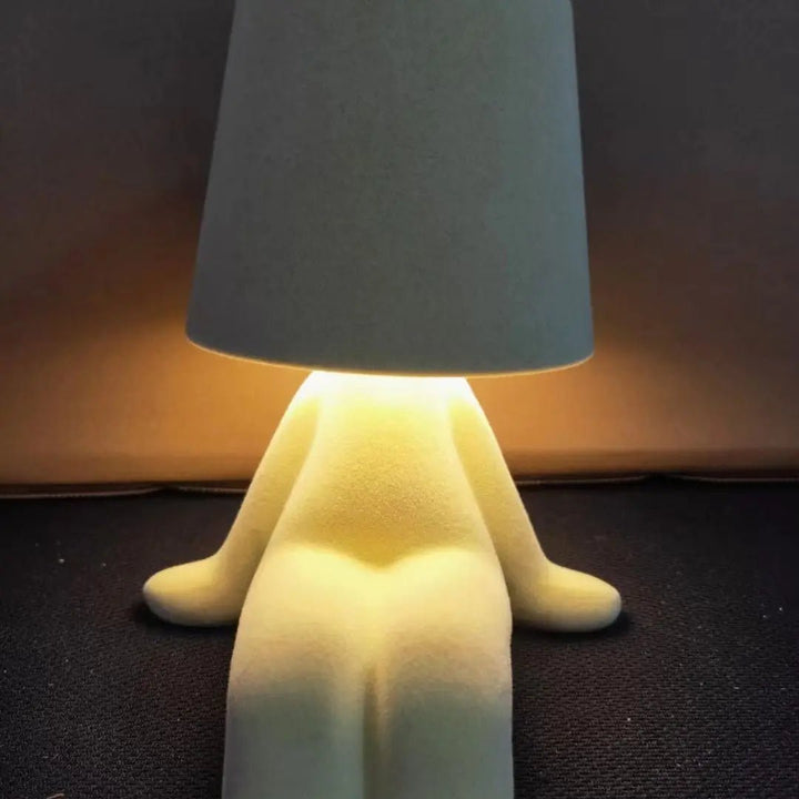 Unique humanoid LED table lamp, a modern decor piece for creative room lighting and ambient glow.