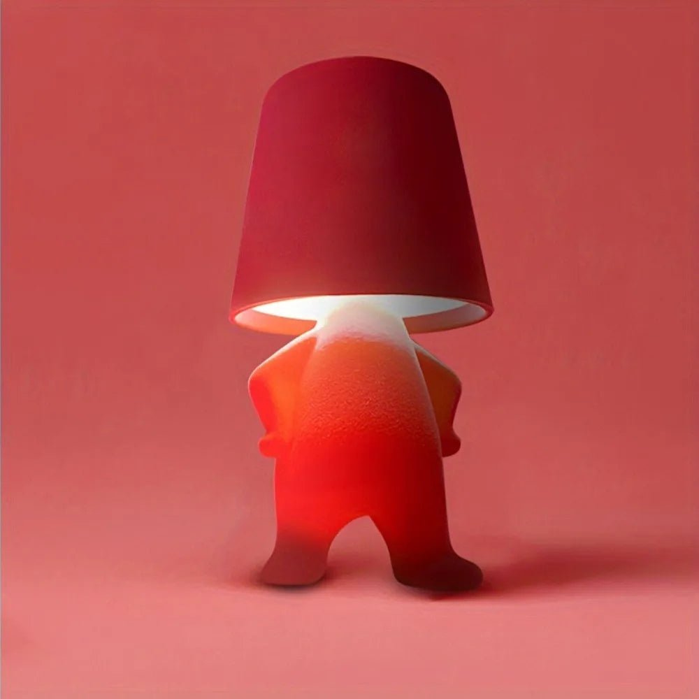 Creative humanoid LED desk lamp, a modern and rechargeable lighting solution for artistic rooms.