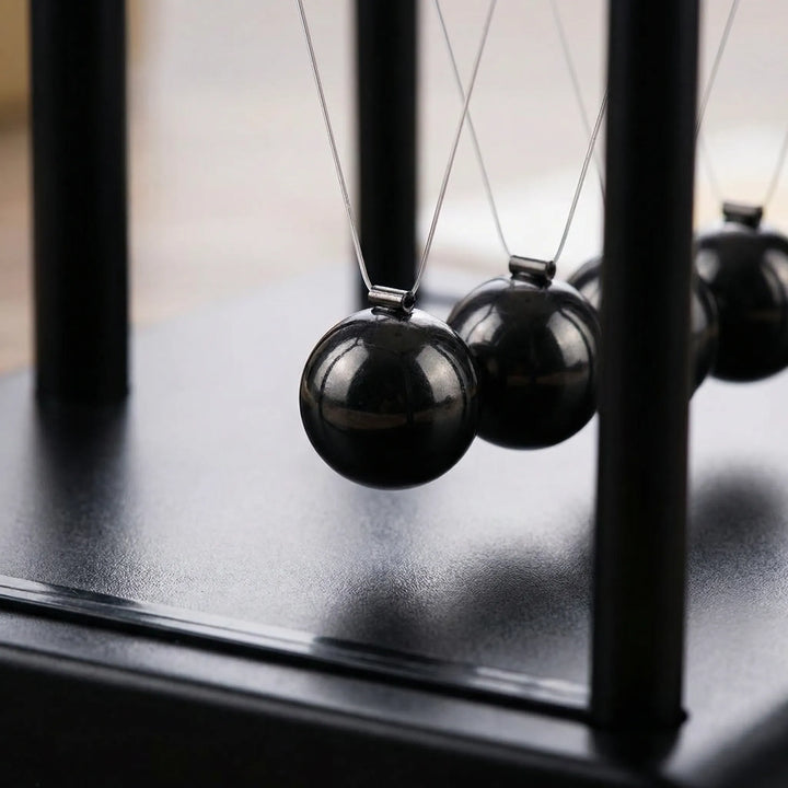 Zen kinetic desk ornament with magnetic movement. A modern tabletop sculpture for office decor, promoting focus & calm.