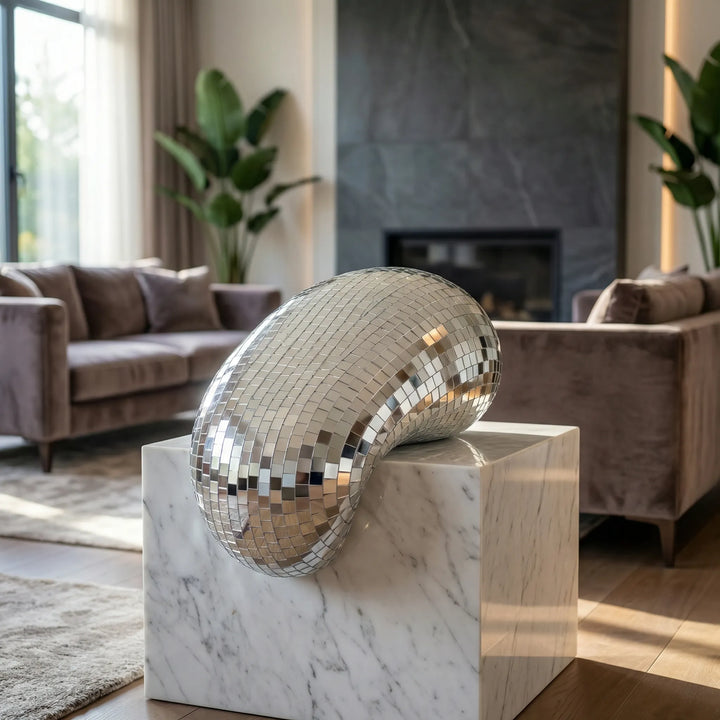 Modern reflective tabletop sculpture, a unique contemporary art piece for living room or office decor.
