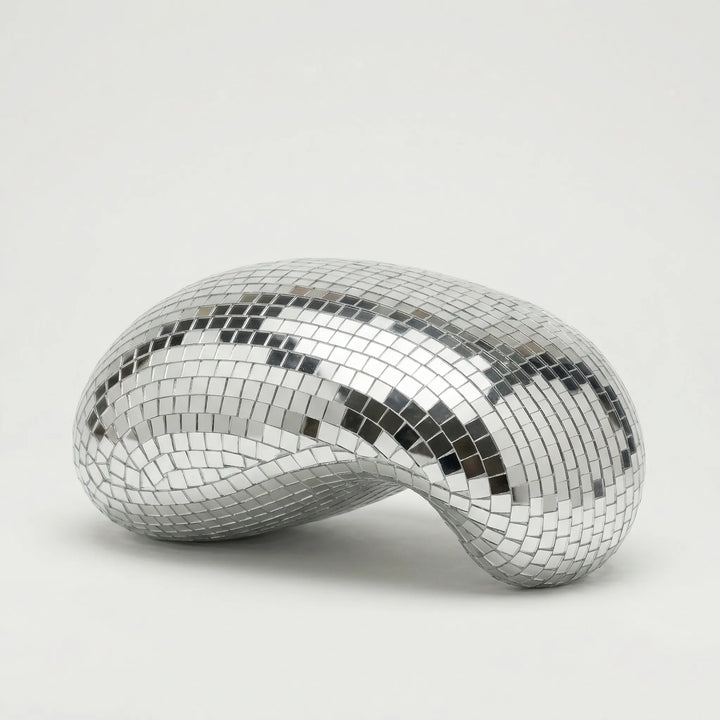 Sleek reflective tabletop sculpture, a modern art accent for contemporary home and office decor.