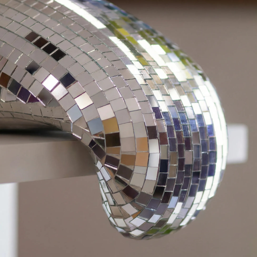 Unique modern reflective tabletop sculpture, a striking artistic statement piece for any home decor.