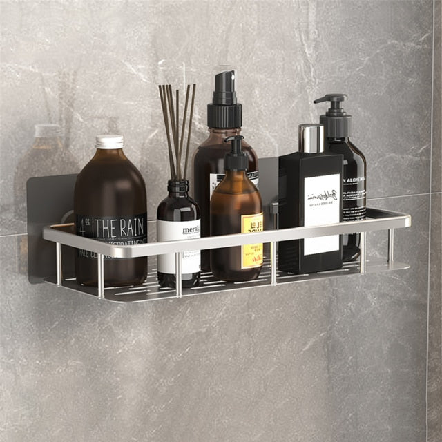 Wall-mounted suction shelf for shampoo and bath essentials.