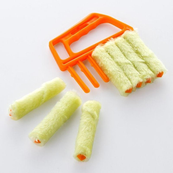 Multi-finger cleaning duster shown removing dirt from between vent slats, reusable design