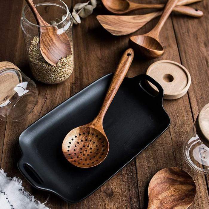 Handcrafted natural teak wood slotted spoon, a durable and eco-friendly wooden cooking tool for any kitchen.